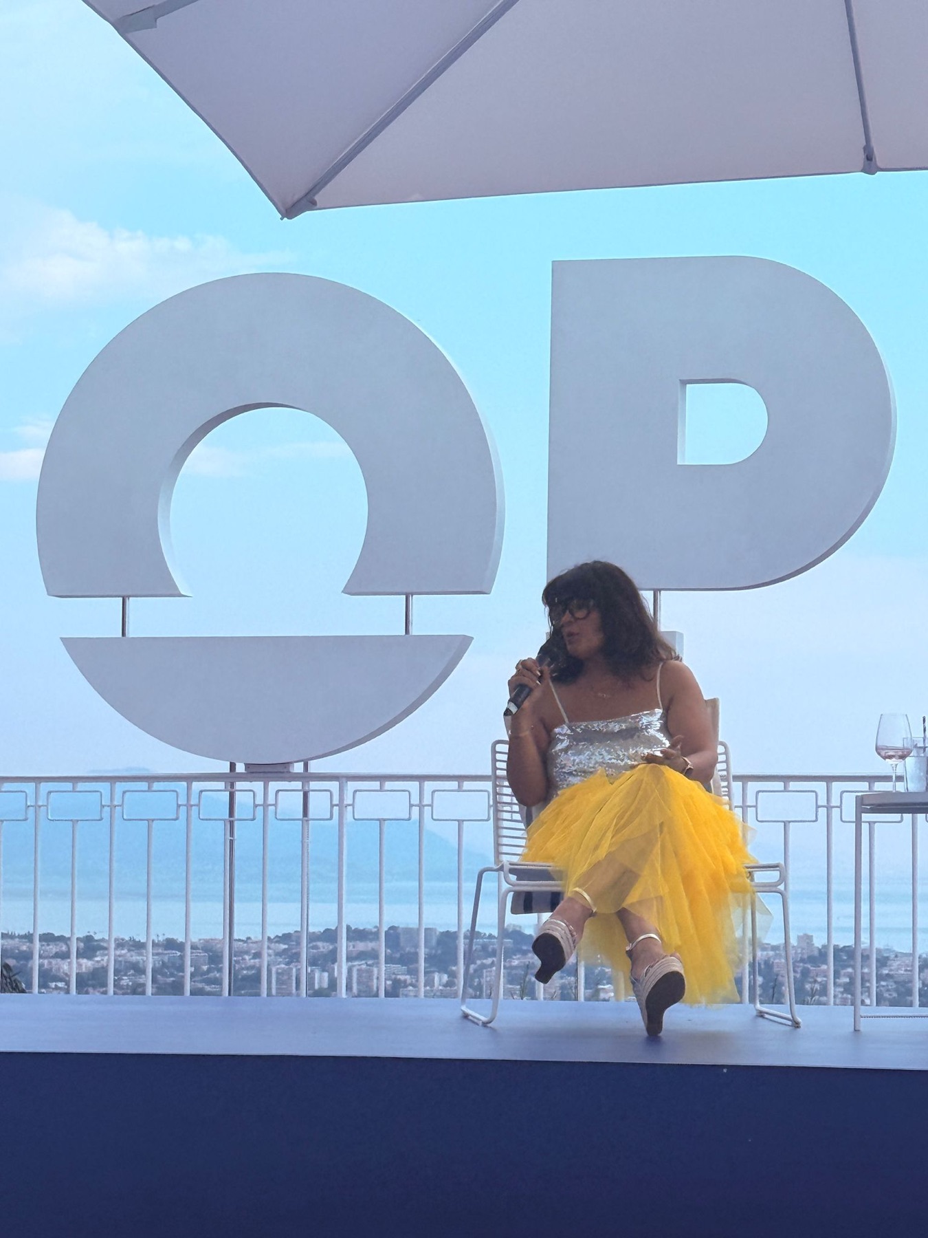 Nishma speaking on a Cannes stage